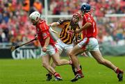 12 September 2004; Timmy McCarthy, Cork, in action against Tommy Walsh, Kilkenny, supported by team-mate Tom Kenny. Guinness All-Ireland Senior Hurling Championship Final, Cork v Kilkenny, Croke Park, Dublin. Picture credit; Damien Eagers / SPORTSFILE *** Local Caption *** Any photograph taken by SPORTSFILE during, or in connection with, the 2004 Guinness All-Ireland Hurling Final which displays GAA logos or contains an image or part of an image of any GAA intellectual property, or, which contains images of a GAA player/players in their playing uniforms, may only be used for editorial and non-advertising purposes.  Use of photographs for advertising, as posters or for purchase separately is strictly prohibited unless prior written approval has been obtained from the Gaelic Athletic Association.