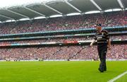 12 September 2004; Kilkenny manager Brian Cody walks the field during the match. Guinness All-Ireland Senior Hurling Championship Final, Cork v Kilkenny, Croke Park, Dublin. Picture credit; Damien Eagers / SPORTSFILE *** Local Caption *** Any photograph taken by SPORTSFILE during, or in connection with, the 2004 Guinness All-Ireland Hurling Final which displays GAA logos or contains an image or part of an image of any GAA intellectual property, or, which contains images of a GAA player/players in their playing uniforms, may only be used for editorial and non-advertising purposes.  Use of photographs for advertising, as posters or for purchase separately is strictly prohibited unless prior written approval has been obtained from the Gaelic Athletic Association.