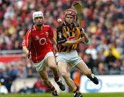 12 September 2004; Tommy Walsh, Kilkenny, in action against Timmy McCarthy, Cork. Guinness All-Ireland Senior Hurling Championship Final, Cork v Kilkenny, Croke Park, Dublin. Picture credit; Damien Eagers / SPORTSFILE *** Local Caption *** Any photograph taken by SPORTSFILE during, or in connection with, the 2004 Guinness All-Ireland Hurling Final which displays GAA logos or contains an image or part of an image of any GAA intellectual property, or, which contains images of a GAA player/players in their playing uniforms, may only be used for editorial and non-advertising purposes.  Use of photographs for advertising, as posters or for purchase separately is strictly prohibited unless prior written approval has been obtained from the Gaelic Athletic Association.