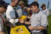 15 September 2004; Paul McGinley, Team Europe 2004, signs autographs for the USA fans during the practice round in advance of the 35th Ryder Cup Matches. Oakland Hills Country Club, Bloomfield Township, Michigan, USA. Picture credit; Matt Browne / SPORTSFILE