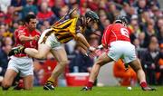 12 September 2004; Ken Coogan, Kilkenny, in action against Sean Og O hAilpin and Ronan Curan (6), Cork. Guinness All-Ireland Senior Hurling Championship Final, Cork v Kilkenny, Croke Park, Dublin. Picture credit; Brian Lawless / SPORTSFILE *** Local Caption *** Any photograph taken by SPORTSFILE during, or in connection with, the 2004 Guinness All-Ireland Hurling Final which displays GAA logos or contains an image or part of an image of any GAA intellectual property, or, which contains images of a GAA player/players in their playing uniforms, may only be used for editorial and non-advertising purposes.  Use of photographs for advertising, as posters or for purchase separately is strictly prohibited unless prior written approval has been obtained from the Gaelic Athletic Association.