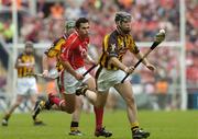 12 September 2004; Ken Coogan, Kilkenny, in action against Sean Og O'hAilpin, Cork. Guinness All-Ireland Senior Hurling Championship Final, Cork v Kilkenny, Croke Park, Dublin. Picture credit; Damien Eagers / SPORTSFILE *** Local Caption *** Any photograph taken by SPORTSFILE during, or in connection with, the 2004 Guinness All-Ireland Hurling Final which displays GAA logos or contains an image or part of an image of any GAA intellectual property, or, which contains images of a GAA player/players in their playing uniforms, may only be used for editorial and non-advertising purposes.  Use of photographs for advertising, as posters or for purchase separately is strictly prohibited unless prior written approval has been obtained from the Gaelic Athletic Association.