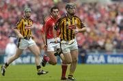 12 September 2004; Ken Coogan, Kilkenny, in action against Sean Og O'hAilpin, Cork. Guinness All-Ireland Senior Hurling Championship Final, Cork v Kilkenny, Croke Park, Dublin. Picture credit; Damien Eagers / SPORTSFILE *** Local Caption *** Any photograph taken by SPORTSFILE during, or in connection with, the 2004 Guinness All-Ireland Hurling Final which displays GAA logos or contains an image or part of an image of any GAA intellectual property, or, which contains images of a GAA player/players in their playing uniforms, may only be used for editorial and non-advertising purposes.  Use of photographs for advertising, as posters or for purchase separately is strictly prohibited unless prior written approval has been obtained from the Gaelic Athletic Association.