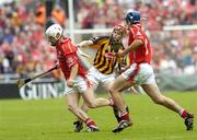 12 September 2004; Timmy McCarthy, Cork, in action against Tommy Walsh, Kilkenny, supported by team-mate Tom Kenny. Guinness All-Ireland Senior Hurling Championship Final, Cork v Kilkenny, Croke Park, Dublin. Picture credit; Damien Eagers / SPORTSFILE *** Local Caption *** Any photograph taken by SPORTSFILE during, or in connection with, the 2004 Guinness All-Ireland Hurling Final which displays GAA logos or contains an image or part of an image of any GAA intellectual property, or, which contains images of a GAA player/players in their playing uniforms, may only be used for editorial and non-advertising purposes.  Use of photographs for advertising, as posters or for purchase separately is strictly prohibited unless prior written approval has been obtained from the Gaelic Athletic Association.
