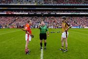 12 September 2004; Cork captain Ben O'Connor, left, and Kilkenny captain Martin Comerford look on as referee Aodan Mac Suibhne makes the toss. Guinness All-Ireland Senior Hurling Championship Final, Cork v Kilkenny, Croke Park, Dublin. Picture credit; Ray McManus / SPORTSFILE *** Local Caption *** Any photograph taken by SPORTSFILE during, or in connection with, the 2004 Guinness All-Ireland Hurling Final which displays GAA logos or contains an image or part of an image of any GAA intellectual property, or, which contains images of a GAA player/players in their playing uniforms, may only be used for editorial and non-advertising purposes.  Use of photographs for advertising, as posters or for purchase separately is strictly prohibited unless prior written approval has been obtained from the Gaelic Athletic Association.