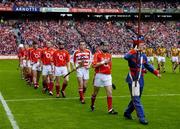 12 September 2004; The Cork team led by Ben O'Connor during the pre-match parade. Guinness All-Ireland Senior Hurling Championship Final, Cork v Kilkenny, Croke Park, Dublin. Picture credit; Ray McManus / SPORTSFILE *** Local Caption *** Any photograph taken by SPORTSFILE during, or in connection with, the 2004 Guinness All-Ireland Hurling Final which displays GAA logos or contains an image or part of an image of any GAA intellectual property, or, which contains images of a GAA player/players in their playing uniforms, may only be used for editorial and non-advertising purposes.  Use of photographs for advertising, as posters or for purchase separately is strictly prohibited unless prior written approval has been obtained from the Gaelic Athletic Association.