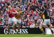 12 September 2004; Joe Deane, Cork, gets his shot away despite the attentions of Kilkenny's Michael Kavanagh, left and goalkeerer James McGarry. Guinness All-Ireland Senior Hurling Championship Final, Cork v Kilkenny, Croke Park, Dublin. Picture credit; Ray McManus / SPORTSFILE *** Local Caption *** Any photograph taken by SPORTSFILE during, or in connection with, the 2004 Guinness All-Ireland Hurling Final which displays GAA logos or contains an image or part of an image of any GAA intellectual property, or, which contains images of a GAA player/players in their playing uniforms, may only be used for editorial and non-advertising purposes.  Use of photographs for advertising, as posters or for purchase separately is strictly prohibited unless prior written approval has been obtained from the Gaelic Athletic Association.