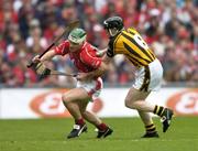 12 September 2004; Niall McCarthy, Cork, in action against Peter Barry, Kilkenny. Guinness All-Ireland Senior Hurling Championship Final, Cork v Kilkenny, Croke Park, Dublin. Picture credit; Ray McManus / SPORTSFILE *** Local Caption *** Any photograph taken by SPORTSFILE during, or in connection with, the 2004 Guinness All-Ireland Hurling Final which displays GAA logos or contains an image or part of an image of any GAA intellectual property, or, which contains images of a GAA player/players in their playing uniforms, may only be used for editorial and non-advertising purposes.  Use of photographs for advertising, as posters or for purchase separately is strictly prohibited unless prior written approval has been obtained from the Gaelic Athletic Association.