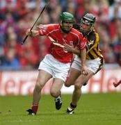 12 September 2004; Jerry O'Connor, Cork, in action against Derek Lyng, Kilkenny. Guinness All-Ireland Senior Hurling Championship Final, Cork v Kilkenny, Croke Park, Dublin. Picture credit; Ray McManus / SPORTSFILE *** Local Caption *** Any photograph taken by SPORTSFILE during, or in connection with, the 2004 Guinness All-Ireland Hurling Final which displays GAA logos or contains an image or part of an image of any GAA intellectual property, or, which contains images of a GAA player/players in their playing uniforms, may only be used for editorial and non-advertising purposes.  Use of photographs for advertising, as posters or for purchase separately is strictly prohibited unless prior written approval has been obtained from the Gaelic Athletic Association.