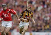 12 September 2004; Tommy Walsh, Kilkenny, in action against Ben O'Connor, Cork. Guinness All-Ireland Senior Hurling Championship Final, Cork v Kilkenny, Croke Park, Dublin. Picture credit; Ray McManus / SPORTSFILE *** Local Caption *** Any photograph taken by SPORTSFILE during, or in connection with, the 2004 Guinness All-Ireland Hurling Final which displays GAA logos or contains an image or part of an image of any GAA intellectual property, or, which contains images of a GAA player/players in their playing uniforms, may only be used for editorial and non-advertising purposes.  Use of photographs for advertising, as posters or for purchase separately is strictly prohibited unless prior written approval has been obtained from the Gaelic Athletic Association.