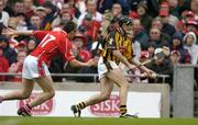 12 September 2004; Eddie Brennan, Kilkenny, in action against John Browne, Cork. Guinness All-Ireland Senior Hurling Championship Final, Cork v Kilkenny, Croke Park, Dublin. Picture credit; Ray McManus / SPORTSFILE *** Local Caption *** Any photograph taken by SPORTSFILE during, or in connection with, the 2004 Guinness All-Ireland Hurling Final which displays GAA logos or contains an image or part of an image of any GAA intellectual property, or, which contains images of a GAA player/players in their playing uniforms, may only be used for editorial and non-advertising purposes.  Use of photographs for advertising, as posters or for purchase separately is strictly prohibited unless prior written approval has been obtained from the Gaelic Athletic Association.