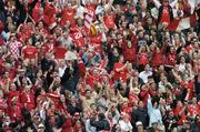 12 September 2004; Cork fans cheer on their side during the game. Guinness All-Ireland Senior Hurling Championship Final, Cork v Kilkenny, Croke Park, Dublin. Picture credit; Ray McManus / SPORTSFILE *** Local Caption *** Any photograph taken by SPORTSFILE during, or in connection with, the 2004 Guinness All-Ireland Hurling Final which displays GAA logos or contains an image or part of an image of any GAA intellectual property, or, which contains images of a GAA player/players in their playing uniforms, may only be used for editorial and non-advertising purposes.  Use of photographs for advertising, as posters or for purchase separately is strictly prohibited unless prior written approval has been obtained from the Gaelic Athletic Association.