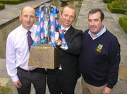 16 September 2004; Paddy Bourke, Erin National Sales Manager, holds the Cross of Cashel trophy with Kilkenny U21 manager Martin Fogarty, left, and Seamus Power, Tipperary Under 21 manager, right, ahead of the Erin U21 All-Ireland Hurling Final which will take place in Nowlan Park, Co. Kilkenny, on Saturday next. Merrion Hotel, Dublin. Picture credit; Pat Murphy / SPORTSFILE