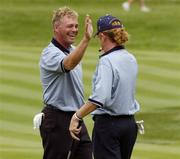 16 September 2004; Darren Clarke, Team Europe 2004, congratulates his playing partner for the day Miguel Angel Jimenez after putting on the 4th green during a practice round in advance of the 35th Ryder Cup Matches. Oakland Hills Country Club, Bloomfield Township, Michigan, USA. Picture credit; Matt Browne / SPORTSFILE