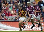 12 September 2004; Richard Hogan, Kilkenny, in action against John Hughes, centre, and Ciaran O'Donovan, Galway. All-Ireland Minor Hurling Championship Final, Galway v Kilkenny, Croke Park, Dublin. Picture credit; Brendan Moran / SPORTSFILE *** Local Caption *** Any photograph taken by SPORTSFILE during, or in connection with, the 2004 Guinness All-Ireland Hurling Final which displays GAA logos or contains an image or part of an image of any GAA intellectual property, or, which contains images of a GAA player/players in their playing uniforms, may only be used for editorial and non-advertising purposes.  Use of photographs for advertising, as posters or for purchase separately is strictly prohibited unless prior written approval has been obtained from the Gaelic Athletic Association.