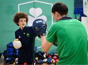 10 April 2025; Olympic athletes Kellie Harrington and Philip Doyle, along with Paralympian Orla Comerford, who are all Dare to Believe ambassadors, attended the Dare to Believe booth at PE Expo 2025, sponsored by Allianz, at the Sport Ireland National Indoor Arena in Dublin. Pictured at the Dare to Believe PE Expo 2025 is Jack Frehill hitting pads held by boxer Adam Hession. Photo by David Fitzgerald/Sportsfile