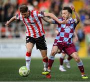 11 April 2025; Ronan Boyce of Derry City in action against Darragh Markey of Drogheda United during the SSE Airtricity Men's Premier Division match between Derry City and Drogheda United at The Ryan McBride Brandywell Stadium in Derry. Photo by Stephen McCarthy/Sportsfile