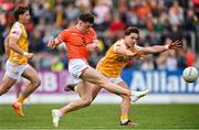 12 April 2025; Tomás McCormack of Armagh shoots to score his side's first goal despite the attention of Eoghan McCabe of Antrim during the Ulster GAA Football Senior Championship quarter-final match between Antrim and Armagh at Corrigan Park in Belfast. Photo by Ramsey Cardy/Sportsfile
