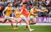 12 April 2025; Tomás McCormack of Armagh shoots to score his side's first goal despite the attention of Eoghan McCabe of Antrim during the Ulster GAA Football Senior Championship quarter-final match between Antrim and Armagh at Corrigan Park in Belfast. Photo by Ramsey Cardy/Sportsfile