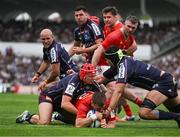 12 April 2025; Alex Nankivell of Munster scores his side's first try despite the tackle of Louis Bielle-Biarrey of Bordeaux Begles during the Investec Champions Cup quarter-final match between Bordeaux Begles and Munster at Stade Chaban-Delmas in Bordeaux, France. Photo by Brendan Moran/Sportsfile