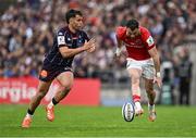 12 April 2025; Andrew Smith of Munster kicks past Damian Penaud of Bordeaux Begles on the way to scoring his side's second try during the Investec Champions Cup quarter-final match between Bordeaux Begles and Munster at Stade Chaban-Delmas in Bordeaux, France. Photo by Brendan Moran/Sportsfile