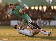 12 April 2025; Josh Murphy of Connacht is tackled by Nolann le Garrec of Racing 92 during the EPCR Challenge Cup quarter-final match between Connacht and Racing 92 at Dexcom Stadium in Galway. Photo by Thomas Flinkow/Sportsfile