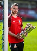 15 April 2025; Ringmahon Rangers FC captain Anthony McAlavey poses for a portrait with the Pat O'Brien FAI Intermediate Challenge Cup during the FAI Intermediate Cup Final media day at Turners Cross Stadium in Cork ahead of the 2025 FAI Intermediate Cup final match between Ringmahon Rangers FC and College Corinthians FC. Photo by Brendan Moran/Sportsfile