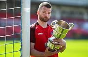 15 April 2025; Ringmahon Rangers FC captain Anthony McAlavey poses for a portrait with the Pat O'Brien FAI Intermediate Challenge Cup during the FAI Intermediate Cup Final media day at Turners Cross Stadium in Cork ahead of the 2025 FAI Intermediate Cup final match between Ringmahon Rangers FC and College Corinthians FC. Photo by Brendan Moran/Sportsfile