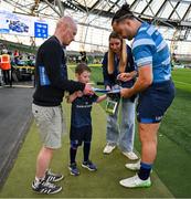 11 April 2025; Leinster mascot Ruadh Roche with Leinster player James Lowe before the Investec Champions Cup quarter-final match between Leinster and Glasgow Warriors at the Aviva Stadium in Dublin. Photo by Brendan Moran/Sportsfile
