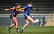13 April 2025; Catherine Dolan of Cavan kicks a point despite the efforts of Aoife Tormey of Wexford during the Lidl Ladies National Football League Division 3 final match between Cavan and Wexford at Integral GAA Grounds in Drogheda, Louth. Photo by Shauna Clinton/Sportsfile
