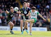 13 April 2025; Shane Tierney of Offaly kicks a point despite the efforts of Ruairí Kinsella of Meath during the Leinster GAA Football Senior Championship quarter-final match between Meath and Offaly at Pairc Tailteann in Navan, Meath. Photo by Thomas Flinkow/Sportsfile