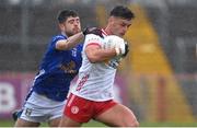 13 April 2025; Michael McKernan of Tyrone in action against Sean McEvoy of Cavan during the Ulster GAA Football Senior Championship quarter-final match between Tyrone and Cavan at O'Neills Healy Park in Omagh, Tyrone. Photo by Ramsey Cardy/Sportsfile