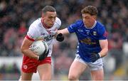 13 April 2025; Conn Kilpatrick of Tyrone in action against Ciarán Brady of Cavan during the Ulster GAA Football Senior Championship quarter-final match between Tyrone and Cavan at O'Neills Healy Park in Omagh, Tyrone. Photo by Ramsey Cardy/Sportsfile