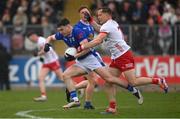 13 April 2025; Niall Carolan of Cavan in action against Kieran McGeary of Tyrone during the Ulster GAA Football Senior Championship quarter-final match between Tyrone and Cavan at O'Neills Healy Park in Omagh, Tyrone. Photo by Ramsey Cardy/Sportsfile
