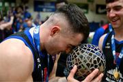 13 April 2025; James Hannigan of UCC Demons celebrates with the trophy after the Domino's Men's Super League final match between UCC Demons and Killester at the National Basketball Arena in Tallaght, Dublin. Photo by Tyler Miller/Sportsfile