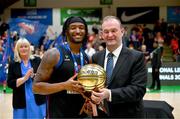 13 April 2025; Patrick Robinson of UCC Demons is presented the MVP Ball by Basketball Ireland CEO John Feehan after the Domino's Men's Super League final match between UCC Demons and Killester at the National Basketball Arena in Tallaght, Dublin. Photo by Tyler Miller/Sportsfile