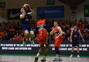 13 April 2025; James Hannigan of UCC Demons shoots ahead of Ciaran Roe, right, and Isiah Dasher of Killester during the Domino's Men's Super League final match between UCC Demons and Killester at the National Basketball Arena in Tallaght, Dublin. Photo by Tyler Miller/Sportsfile