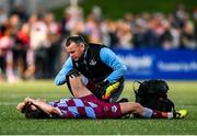 11 April 2025; Darragh Markey of Drogheda United receives medical attention from physiotherapist Keith Browne during the SSE Airtricity Men's Premier Division match between Derry City and Drogheda United at The Ryan McBride Brandywell Stadium in Derry. Photo by Stephen McCarthy/Sportsfile