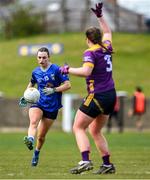 13 April 2025; Aisling Gilsenan of Cavan kicks past Maria Byrne during the Lidl Ladies National Football League Division 3 final match between Cavan and Wexford at Integral GAA Grounds in Drogheda, Louth. Photo by Shauna Clinton/Sportsfile