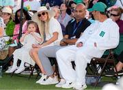13 April 2025; Rory McIlroy's wife Erica Stoll and their daughter Poppy with caddie Harry Diamond, right, during the green jacket ceremony after his playoff victory in the final round of the Masters Tournament at Augusta National Golf Club in Georgia, USA. Photo by Kyle Terada/Imagn Images via Sportsfile