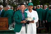 13 April 2025; Rory McIlroy of Northern Ireland and his caddie Harry Diamond with the Masters Championship trophy after victory in the final round of the Masters Tournament at Augusta National Golf Club in Georgia, USA. Photo by Michael Madrid/Imagn Images via Sportsfile