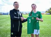 17 April 2025; Ava Hallinan of Republic of Ireland is presented with her jersey by Republic of Ireland head coach Richard Berkeley after the Girls U15 SAFIB Bob Docherty Cup match between Northern Ireland and Republic of Ireland at Greenisland FC in Antrim. Photo by Seb Daly/Sportsfile