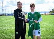 17 April 2025; Leah O’Leary Callender of Republic of Ireland is presented with her jersey by Republic of Ireland head coach Richard Berkeley after the Girls U15 SAFIB Bob Docherty Cup match between Northern Ireland and Republic of Ireland at Greenisland FC in Antrim. Photo by Seb Daly/Sportsfile