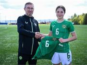 17 April 2025; Lara Dallaghan of Republic of Ireland is presented with her jersey by Republic of Ireland head coach Richard Berkeley after the Girls U15 SAFIB Bob Docherty Cup match between Northern Ireland and Republic of Ireland at Greenisland FC in Antrim. Photo by Seb Daly/Sportsfile