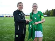 17 April 2025; Ciara Milton of Republic of Ireland is presented with her jersey by Republic of Ireland head coach Richard Berkeley after the Girls U15 SAFIB Bob Docherty Cup match between Northern Ireland and Republic of Ireland at Greenisland FC in Antrim. Photo by Seb Daly/Sportsfile