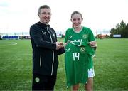 17 April 2025; Hailey Twomey of Republic of Ireland is presented with her jersey by Republic of Ireland head coach Richard Berkeley after the Girls U15 SAFIB Bob Docherty Cup match between Northern Ireland and Republic of Ireland at Greenisland FC in Antrim. Photo by Seb Daly/Sportsfile