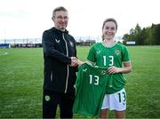 17 April 2025; Maisy Healy of Republic of Ireland is presented with her jersey by Republic of Ireland head coach Richard Berkeley after the Girls U15 SAFIB Bob Docherty Cup match between Northern Ireland and Republic of Ireland at Greenisland FC in Antrim. Photo by Seb Daly/Sportsfile