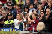12 April 2025; Kate Geraghty of Galway is presented with the cup by Uachtarán Cumann Peil Gael na mBan, Trina Murray after her side's victory in the Lidl Ladies National Football League Division 2 final match between Cork and Galway at Croke Park in Dublin. Photo by Sam Barnes/Sportsfile