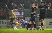 18 April 2025; Warren Davis of Drogheda United is tackled by Mark Coyle of Shelbourne, centre, and Sam Bone during the SSE Airtricity Men's Premier Division match between Drogheda United and Shelbourne at Sullivan & Lambe Park in Drogheda, Louth. Photo by Ben McShane/Sportsfile