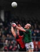 19 April 2025; Daniel Guinness of Down in action against Ché Cullen of Fermanagh during the Ulster GAA Football Senior Championship quarter-final match between Fermanagh and Down at Brewster Park in Enniskillen, Fermanagh. Photo by Ramsey Cardy/Sportsfile
